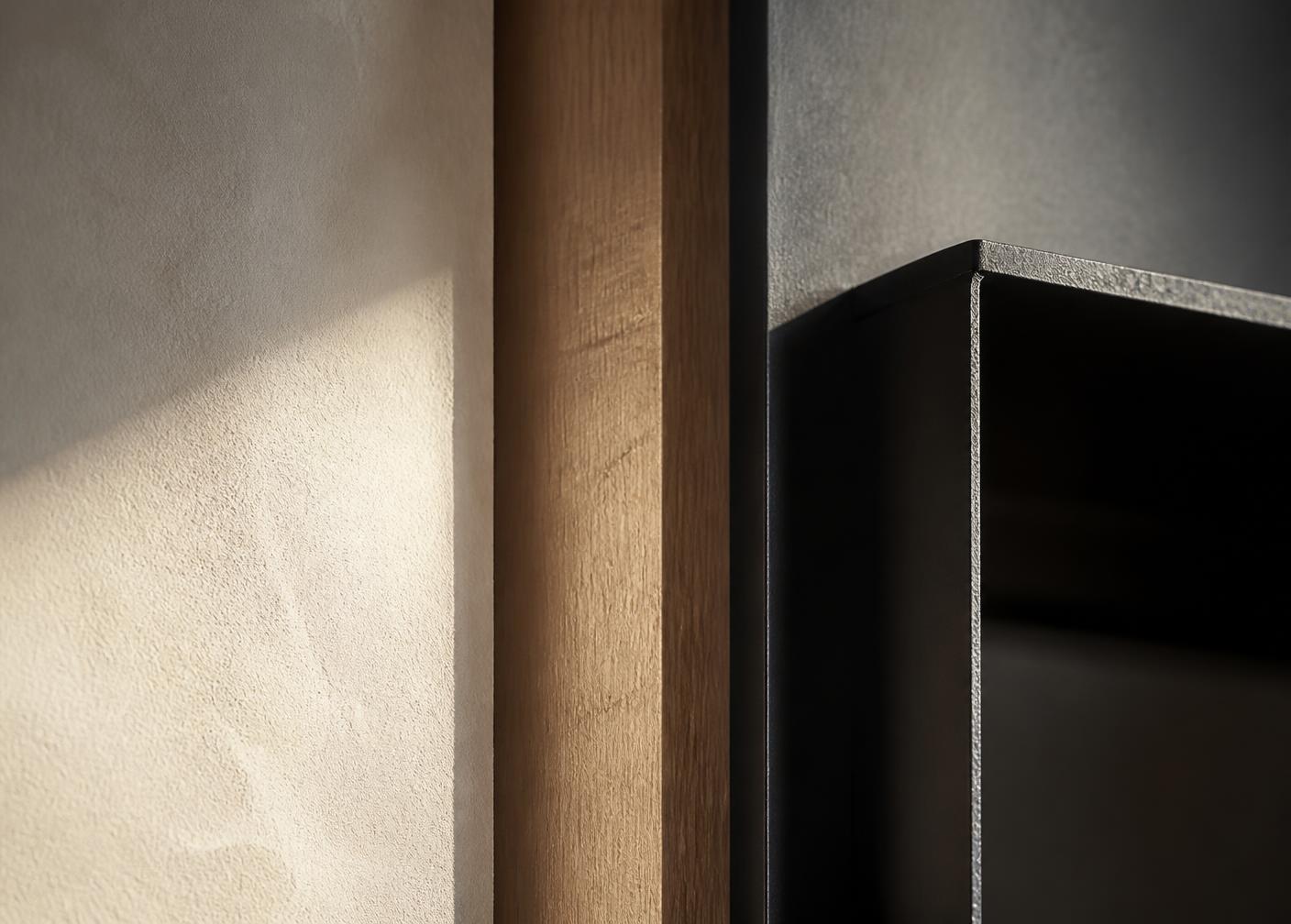 Close detail of brass inlay meeting oak joinery and plaster wall